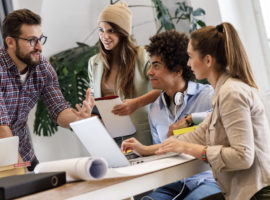 Group of casually dressed young  businesspeople discussing ideas