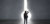 Find a solution and way concept with back of pensive businesswoman grabbing her head in black suit looking at big bright and glowing keyhole in grey wall