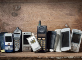 Old and obsolete mobile phone or cell phones on space of old woo
